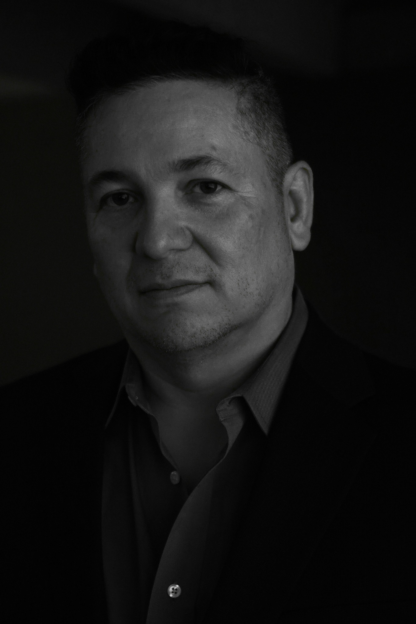 Black and white portrait of Aaron Alexander in a suit